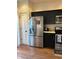 Modern kitchen featuring stainless steel appliances and dark cabinetry at 9535 Longwell Dr, Indianapolis, IN 46240