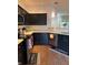Modern kitchen featuring black cabinets, stainless steel appliances, and good lighting at 9535 Longwell Dr, Indianapolis, IN 46240