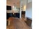 Stylish kitchen with black cabinets, stainless steel appliances, and wood-look flooring at 9535 Longwell Dr, Indianapolis, IN 46240