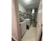 Laundry room with large washing machine and dryer plus storage shelves at 9535 Longwell Dr, Indianapolis, IN 46240