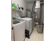Laundry room with large washing machine and dryer plus storage shelves at 9535 Longwell Dr, Indianapolis, IN 46240