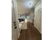 Open-concept living room with hardwood floors, a fireplace, and seamless flow to dining and kitchen areas at 9535 Longwell Dr, Indianapolis, IN 46240