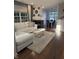 Stylish living room with hardwood floors, a fireplace, and a comfortable white sofa overlooking the dining room at 9535 Longwell Dr, Indianapolis, IN 46240