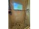 Stylish shower with a window, built-in shelving, and decorative stone floor at 9535 Longwell Dr, Indianapolis, IN 46240