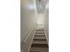 Bright staircase with wooden steps and chandelier at 9535 Longwell Dr, Indianapolis, IN 46240