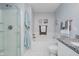 Bright bathroom showcases white tile, a tub with shower, and stylish wall art accents at 9689 Wild Iris Dr, Noblesville, IN 46060