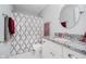 This bathroom features a granite-topped vanity and a shower-tub combo with patterned curtain at 9689 Wild Iris Dr, Noblesville, IN 46060