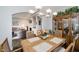 Open dining space with seating for six, visible from living area; stylish hardwood floors and hutch at 9689 Wild Iris Dr, Noblesville, IN 46060