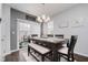 Open dining room with modern table, bench seating, and natural light at 9689 Wild Iris Dr, Noblesville, IN 46060