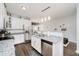 Bright kitchen with stainless steel appliances, granite countertops, white cabinetry, and stylish lighting at 9689 Wild Iris Dr, Noblesville, IN 46060