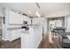 Bright kitchen with white cabinets, granite countertops, and stainless steel appliances open to dining area at 9689 Wild Iris Dr, Noblesville, IN 46060