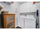 Functional laundry room with white cabinets and modern washer/dryer at 9689 Wild Iris Dr, Noblesville, IN 46060