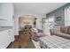Open-concept living area showcasing hardwood floors, comfortable seating, and a dining room view at 9689 Wild Iris Dr, Noblesville, IN 46060
