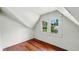 The attic features a double window with wooden floors at 102 N Whitcomb Ave, Indianapolis, IN 46224