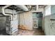 An unfinished basement with exposed piping shows a furnace at 102 N Whitcomb Ave, Indianapolis, IN 46224