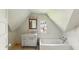 Attic bathroom featuring sloped ceilings, vanity, and a bathtub at 102 N Whitcomb Ave, Indianapolis, IN 46224