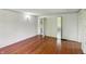 A spacious bedroom featuring hardwood floors and access to an ensuite bathroom at 102 N Whitcomb Ave, Indianapolis, IN 46224