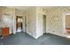 Bedroom with floral wallpaper, closet, and doorways to other rooms at 102 N Whitcomb Ave, Indianapolis, IN 46224
