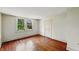 Bright bedroom with wood floors and natural light streaming through the window at 102 N Whitcomb Ave, Indianapolis, IN 46224