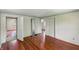 An interior view shows hardwood floors and multiple entry ways to other rooms at 102 N Whitcomb Ave, Indianapolis, IN 46224