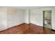 Bedroom featuring classic wood floors, white trim, and multiple doorways at 102 N Whitcomb Ave, Indianapolis, IN 46224