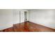 Bedroom with polished wood floors and a classic white door at 102 N Whitcomb Ave, Indianapolis, IN 46224