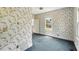 Bedroom featuring floral wallpaper and natural light from a large window at 102 N Whitcomb Ave, Indianapolis, IN 46224