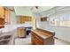 Cozy kitchen with wood cabinets and a new oven, ready for renovation at 102 N Whitcomb Ave, Indianapolis, IN 46224