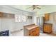 Cozy kitchen with wood cabinets and stainless steel refrigerator, ready for renovation at 102 N Whitcomb Ave, Indianapolis, IN 46224