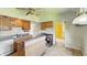 Cozy kitchen with wood cabinets and tiled floors, ready for renovation at 102 N Whitcomb Ave, Indianapolis, IN 46224