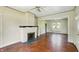 Bright living room featuring a brick fireplace and hardwood floors at 102 N Whitcomb Ave, Indianapolis, IN 46224