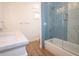 Well-lit bathroom featuring tiled shower, tub, and marble sink at 1156 Spruce St, Indianapolis, IN 46203