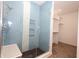Stylish shower featuring blue tile, a glass door, and built-in shelving at 1156 Spruce St, Indianapolis, IN 46203