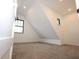 Cozy bedroom with neutral paint, angled ceiling and 2 windows for natural light at 1156 Spruce St, Indianapolis, IN 46203
