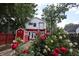 Exterior view of house with roses, red shed and balcony at 1156 Spruce St, Indianapolis, IN 46203