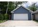 Detached one-car garage with horizontal siding and a white door, perfect for storage and parking at 1156 Spruce St, Indianapolis, IN 46203