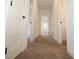 Neutral hallway with multiple white panel doors, tan carpeting and great sight lines at 1156 Spruce St, Indianapolis, IN 46203
