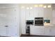 Modern kitchen featuring custom white cabinetry, stainless steel appliances and stylish finishes at 1156 Spruce St, Indianapolis, IN 46203