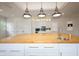 Spacious updated kitchen with stainless appliances, wood floors and a large center island at 1156 Spruce St, Indianapolis, IN 46203