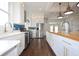 Bright kitchen with white cabinets, wood counters, stainless steel appliances, and eye-catching blue tile backsplash at 1156 Spruce St, Indianapolis, IN 46203