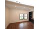 Sun-lit living room features hardwood floors, neutral paint, built in storage and two windows at 1156 Spruce St, Indianapolis, IN 46203