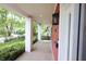 Covered porch with brick columns overlooks the neighborhood and features updated lighting at 1156 Spruce St, Indianapolis, IN 46203