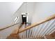 Staircase with decorative chandelier, white railing, wooden stairs and a patterned tile landing at 1156 Spruce St, Indianapolis, IN 46203