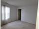 Bedroom with neutral carpet and white walls illuminated by light filtering through a window at 11754 Hamble Dr, Indianapolis, IN 46235