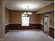 Traditional dining room featuring two-tone paint, a chandelier, carpet, and natural light at 11754 Hamble Dr, Indianapolis, IN 46235