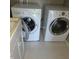 Bright laundry area featuring an LG washing machine and dryer, along with laminate floors at 11754 Hamble Dr, Indianapolis, IN 46235