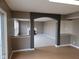 Open living room with wood floors, and gray pillars showcasing the Gathering room with fireplace in the back at 11754 Hamble Dr, Indianapolis, IN 46235