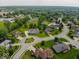 Aerial view of a neighborhood showcasing well-maintained homes with lush green lawns and mature trees at 120 Wagon Trail, Mooresville, IN 46158