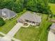 An aerial view of a brick home showcasing its spacious yard, lush greenery, and inviting outdoor living space at 120 Wagon Trail, Mooresville, IN 46158