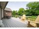 Deck with chairs and dining table overlooking the beautifully landscaped backyard at 120 Wagon Trail, Mooresville, IN 46158